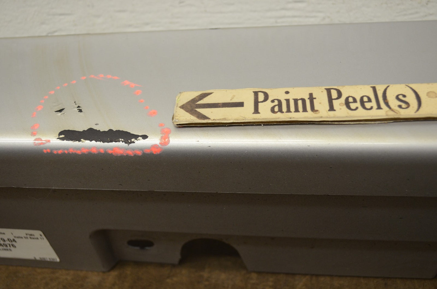 BMW F10 rocker panel molding — scratch and paint peel detail