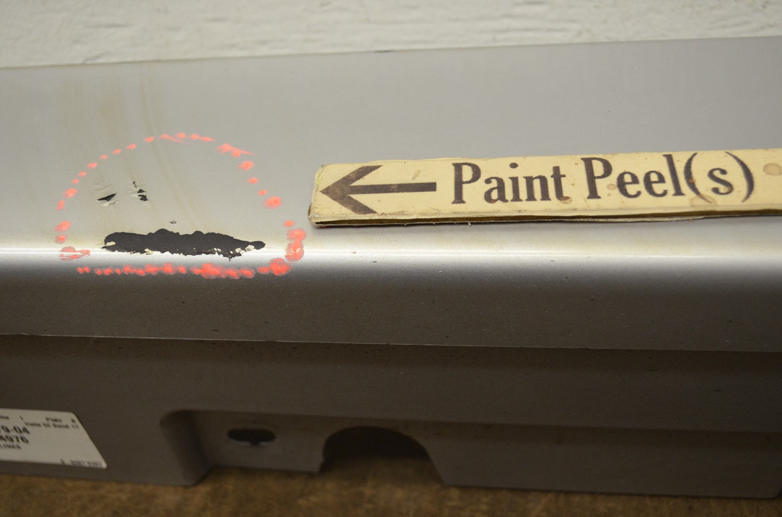 BMW F10 rocker panel molding — scratch and paint peel detail